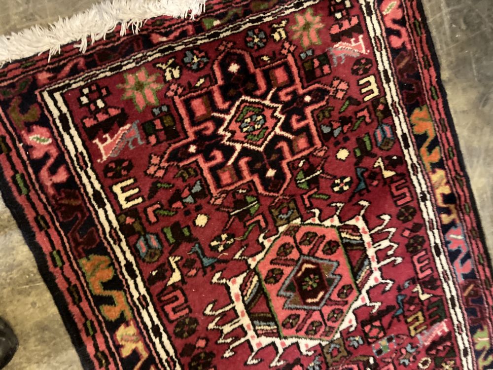 A Persian woollen red ground runner, 300 x 78cm